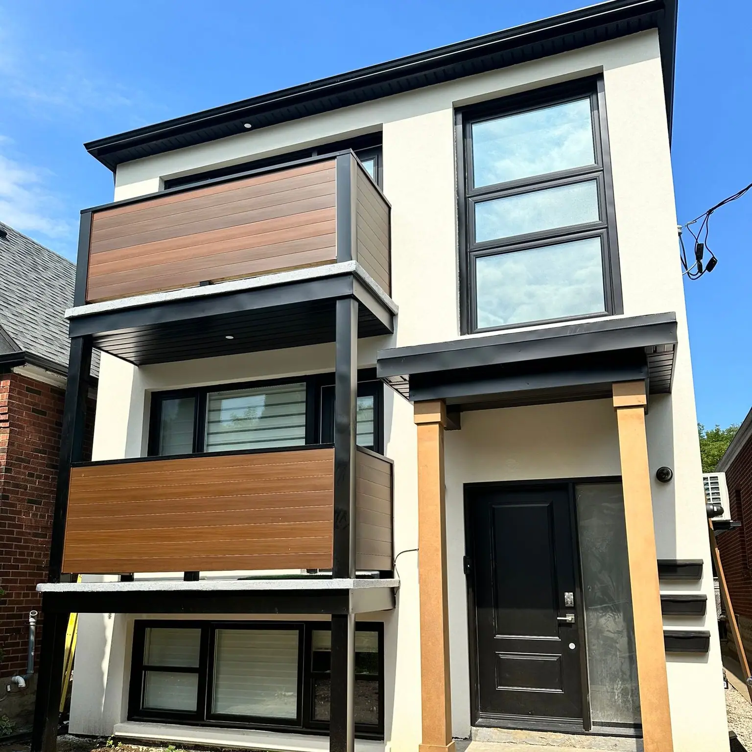 Before and after: a three-storey rear addition with balconies, framed and then finished, by CCS Group
