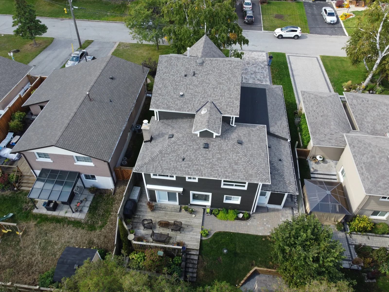 Drone view of a second-storey addition, the tallest house among the bungalows on its street