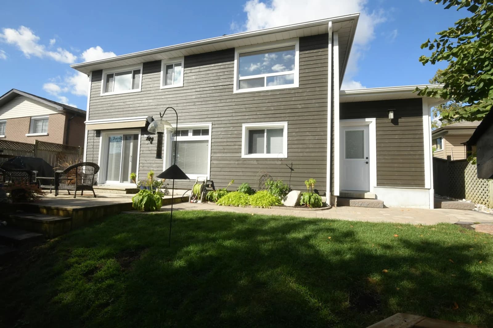Rear of the finished second-storey addition with new windows and deck