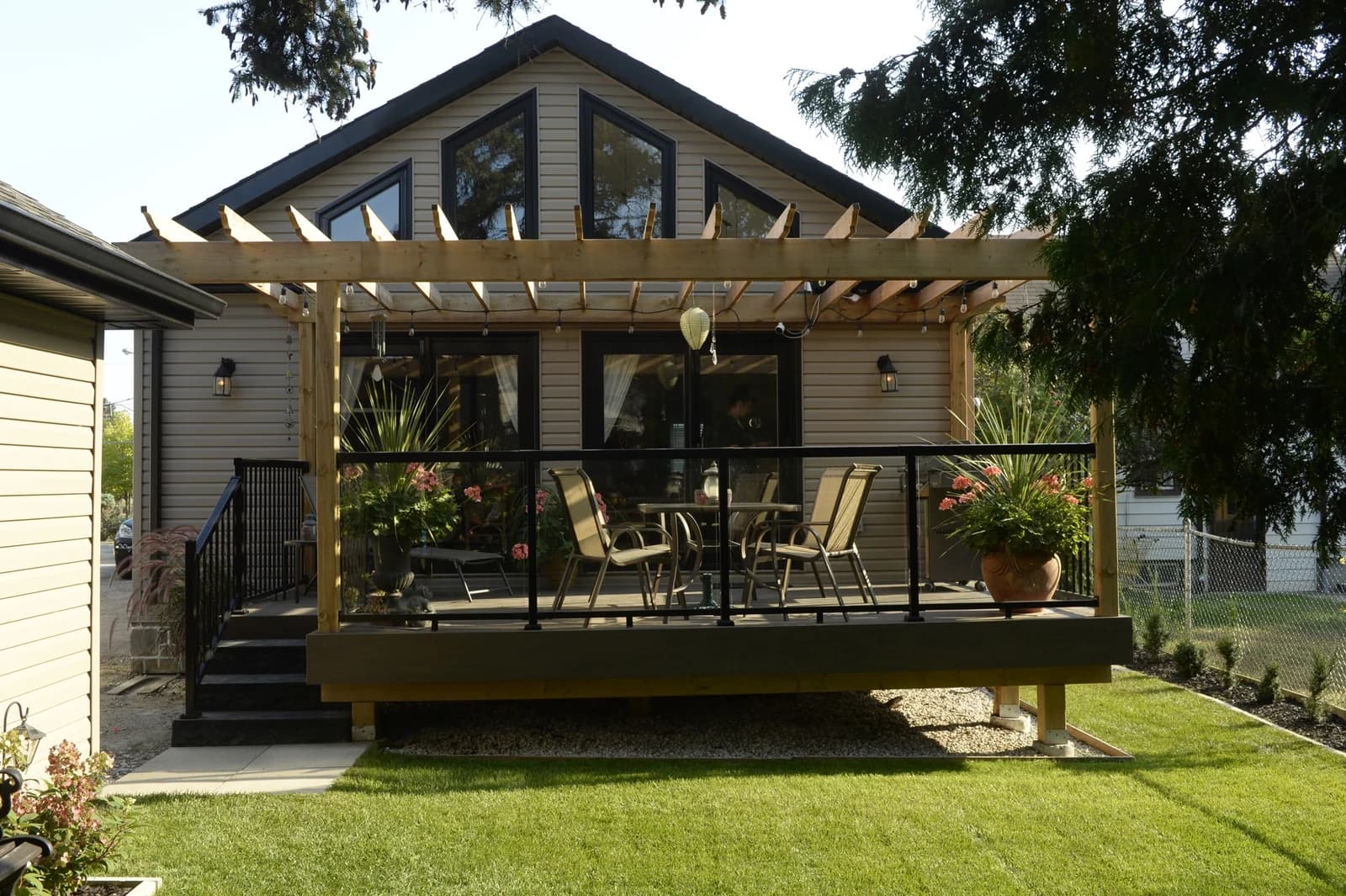 Rear extension with a vaulted gable, floor-to-ceiling windows, pergola and deck