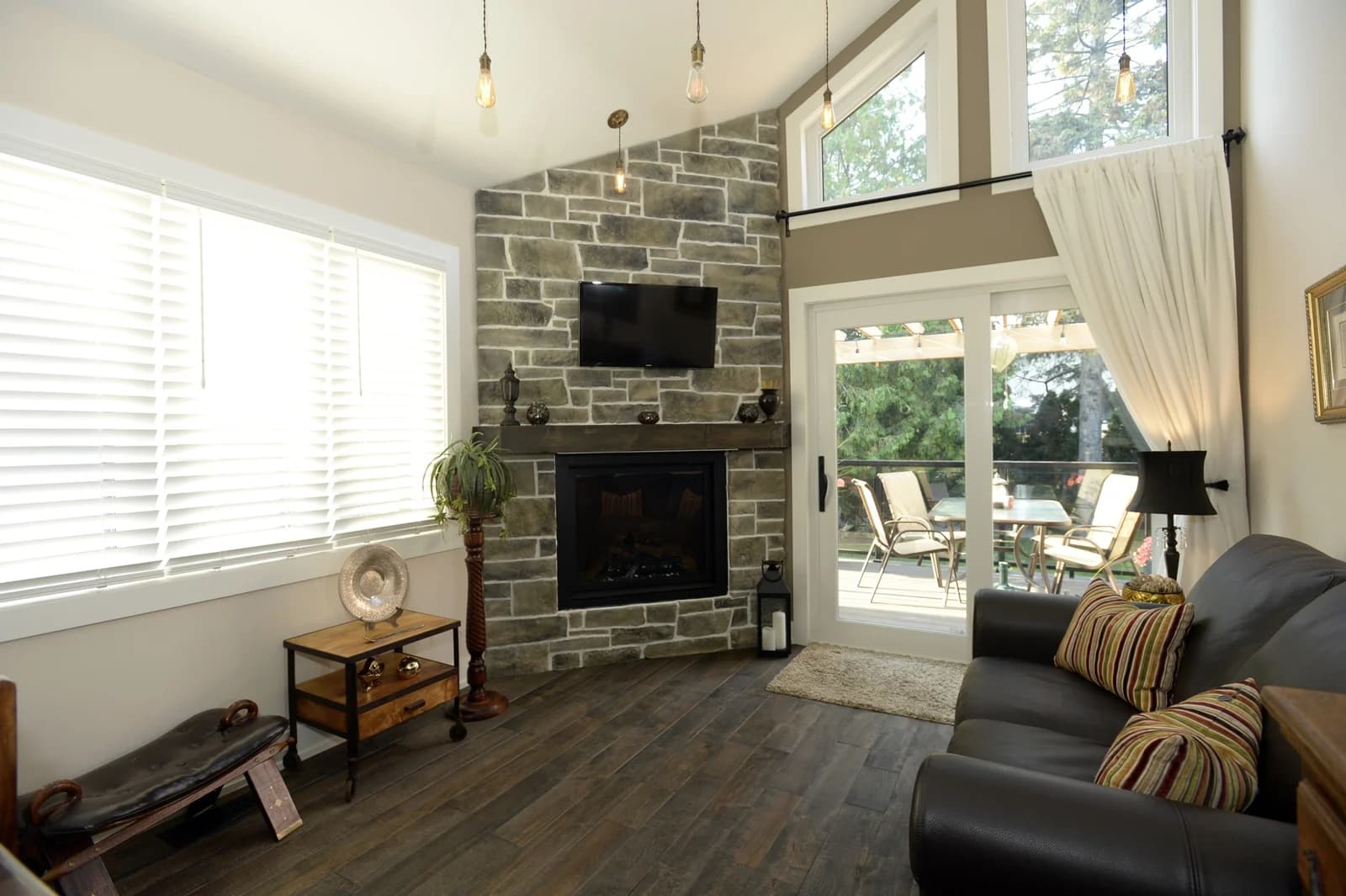 Vaulted great room inside the rear extension, stone fireplace and exposed beams