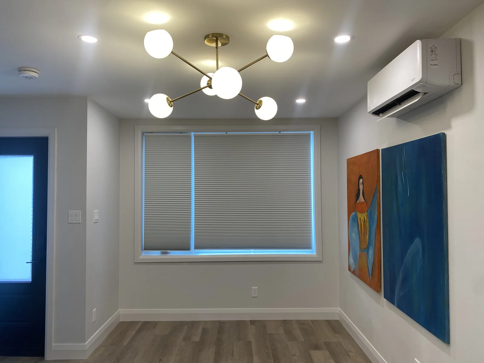 Laneway suite living room with ductless heat pump and large window