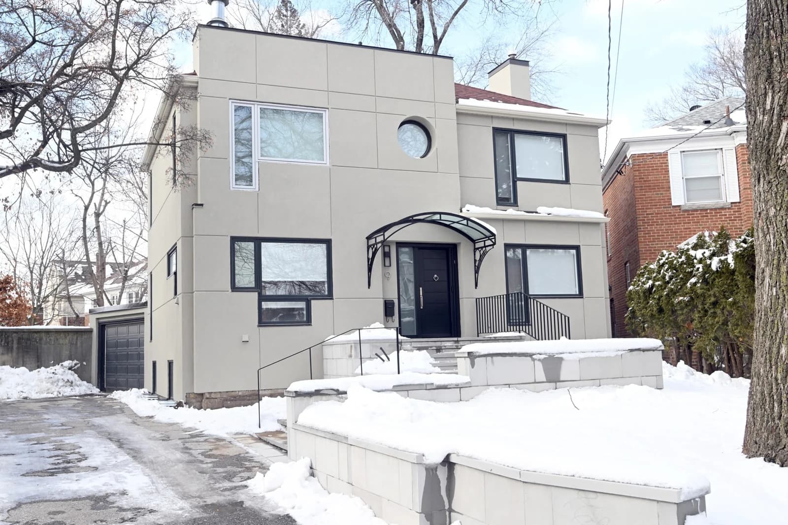 Stucco second-storey addition on a Toronto home, winter view
